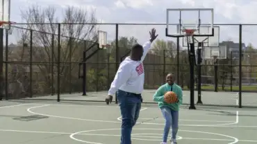 Joseph Yusuf plays basketball with his daughter, Jakayla Morton, 11, in Alexandria, Va., on March 29. Keren Carrión/NPR