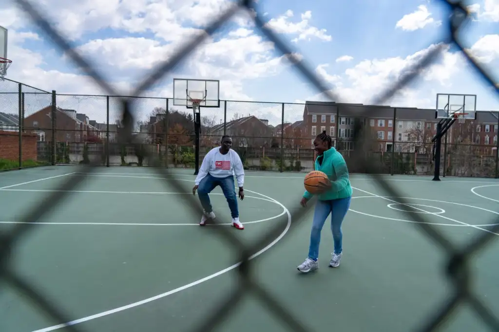 Joseph Yousef plays basketball with his daughter, Jakayla Morton, 11, in Alexandria, VA., on March 29.
Keren Carrión/NPR